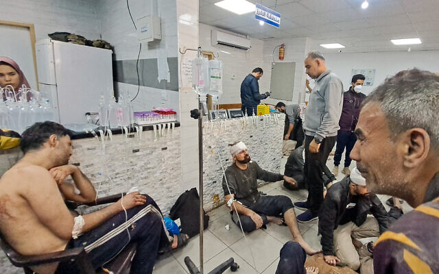 Wounded Palestinians wait at the Kamal Adwan Hospital in Beit Lahia, Gaza Strip, on November 21, 2023. (AFP)