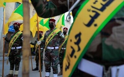 Members of the Hezbollah brigades, Kataeb Hezbollah, attend the funeral of Fadel al-Maksusi, a fighter who was also part of the Islamic Resistance in Iraq, the group that has claimed all recent attacks against US troops in Iraq and Syria, in Baghdad on November 21, 2023. (AHMAD AL-RUBAYE / AFP)