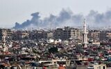 File: Smoke billows above buildings after an Israeli strike on the outskirts of Damascus on November 22, 2023. (AFP)