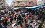 Crowds of people shop in an open-air market in the southern Gaza Strip city of Khan Younis on November 28, 2023. (Mohammed Abed/ AFP)