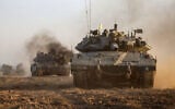 IDF tanks roll near the border with the Gaza Strip on December 3, 2023, amid continuing battles between Israel and the Hamas terror group. (Menahem KAHANA / AFP)