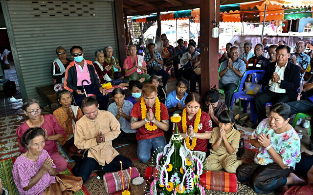Freed Thai couple Boonthom Pankhong (center L) and Natthawaree Mulkan (center R), who were held hostage by Hamas terrorists following the October 7 assault on Israel, take part in a traditional welcoming ceremony for their safe return to Thailand, at their house in Thailand's northeastern Udon Thani province on December 6, 2023. (Manan VATSYAYANA / AFP) Freed Thai couple Boonthom Pankhong (center L) and Natthawaree Mulkan (center R), who were held hostage by Hamas terrorists following the October 7 assault on Israel, take part in a traditional welcoming ceremony for their safe return to Thailand, at their house in Thailand's northeastern Udon Thani province on December 6, 2023. (Manan VATSYAYANA / AFP)