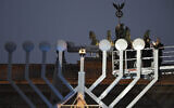 Rabbi Yehuda Teichtal (2nd R) and German Chancellor Olaf Scholz (R) light the giant Menorah for Hanukkah, in Berlin at the Brandenburg Gate on December 7, 2023. (Tobias Schwarz/AFP)
