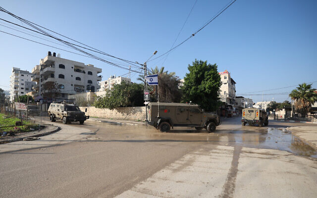 Israeli military vehicles enter the Jenin camp in the West Bank during a raid on December 12, 2023. (Jaafar ASHTIYEH / AFP)