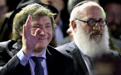 Argentina's President Javier Milei waves at a lighting of a menorah on Hanukkah in Buenos Aires on December 12, 2023. (Juan Mabromata/AFP)