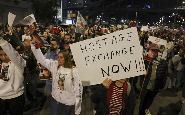 Families and supporters of hostages held by terrorists since the October 7 assault hold a demonstration outside the Defense Ministry in Tel Aviv on December 15, 2023. (Ahmad Gharabli/AFP)