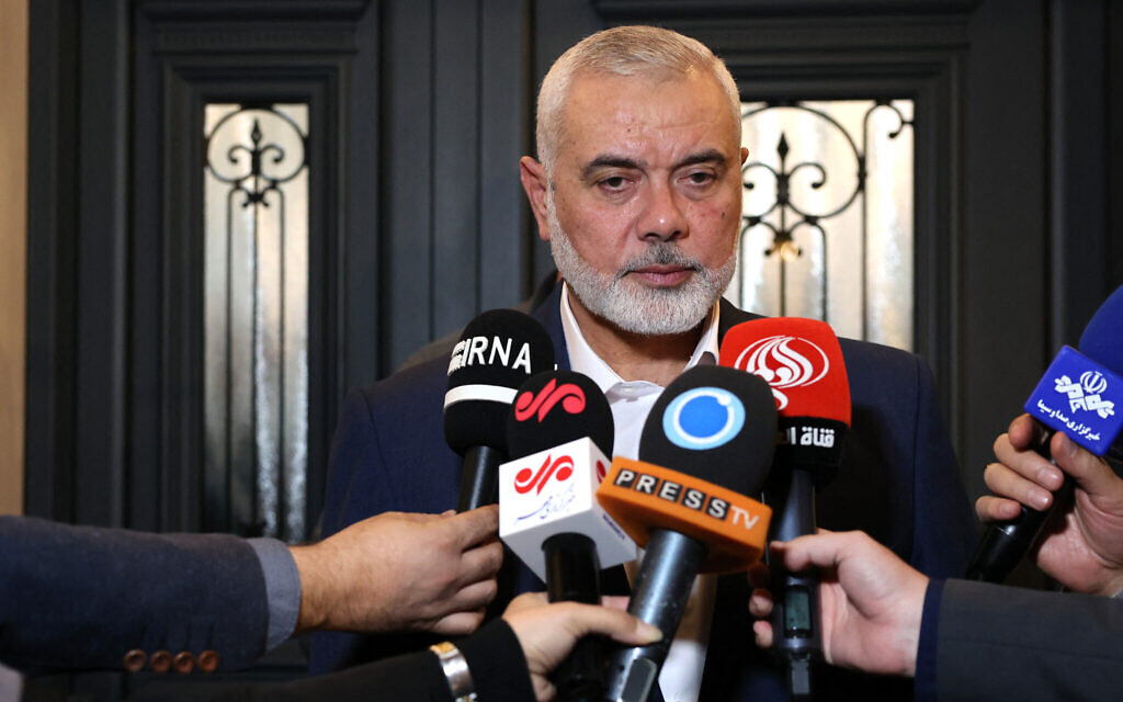This handout picture provided by the Iranian foreign ministry on December 20, 2023, shows Qatar-based Hamas politburo leader Ismail Haniyeh speaking to journalists as he welcomes the Iranian foreign minister (not in the picture), in Doha. (Photo by Iranian Foreign Ministry / AFP)