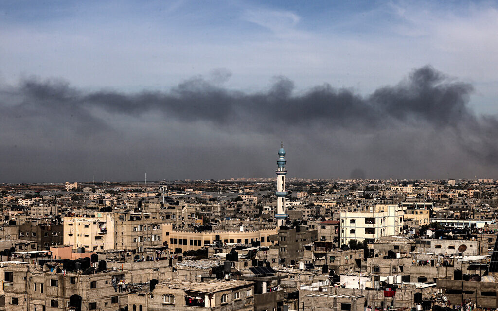 A picture taken from Rafah shows smoke billowing over Khan Younis in the southern Gaza Strip during an Israeli bombardment on December 20, 2023, amid the ongoing between Israel and the Palestinian terror group Hamas. (Said Khatib/AFP)