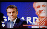 A television screen broadcasting French TV channel France 5 as French President Emmanuel Macron speaks during an interview in the 'C a vous' TV show, at the Elysee Presidential Palace, in Paris, December 20, 2023. (Ludovic MARIN / AFP)