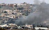 A picture taken from southern Israel near the border with the Gaza Strip on December 21, 2023, shows smoke billowing amid the destruction in northern Gaza. (Jack Guez/AFP)