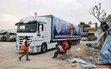 Trucks carrying humanitarian aid enter the Gaza Strip at the Kerem Shalom crossing in the southern Gaza Strip, December 21, 2023. (Mohammed ABED / AFP)