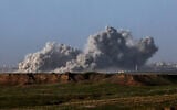 A picture taken from southern Israel bordering the Gaza Strip on December 22, 2023, shows smoke billowing following an Israeli bombardment in the coastal enclave amid the ongoing war with the Hamas terror group. (Jack Guez/AFP)