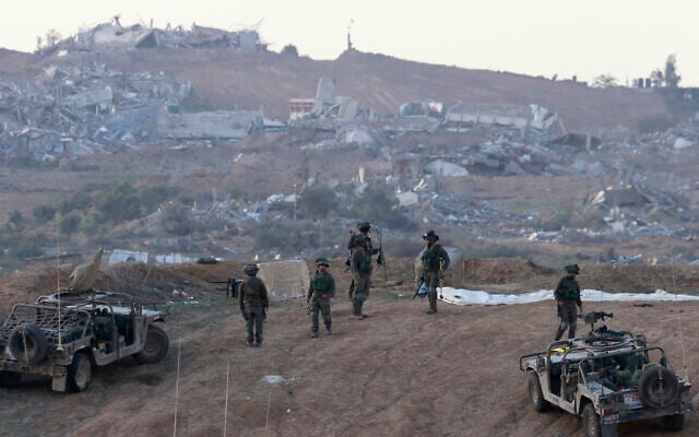 A picture taken in southern Israel near the border with the Gaza Strip on December 24, 2023, shows Israeli soldiers taking a position near the Palestinian enclave amid continuing battles between Israel and Hamas. (Menahem KAHANA/AFP) A picture taken in southern Israel near the border with the Gaza Strip on December 24, 2023, shows Israeli soldiers taking a position near the Palestinian enclave amid continuing battles between Israel and Hamas. (Menahem KAHANA/AFP)