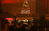 A message in support of Gaza is displayed on a building next to the square of the Church of the Nativity in Bethlehem on December 24, 2023. (HAZEM BADER / AFP)