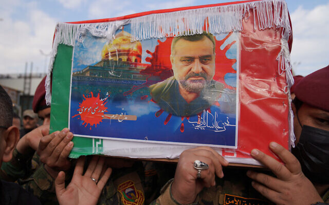 Honor guards carry the coffin of Razi Moussavi, a senior commander in the Quds Force of Iran's Islamic Revolutionary Guard Corps who was killed in an Israeli strike in Syria, during his funeral procession at the Imam Ali shrine in Iraq's holy city of Najaf, on December 27, 2023. (Qassem al-Kaabi/AFP)
