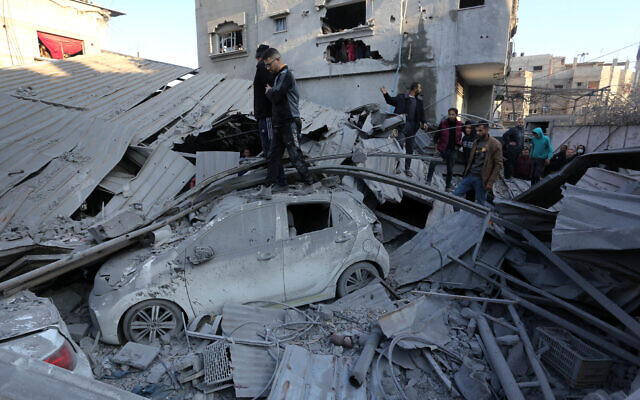 Palestinians inspect the damage following Israeli strikes on the Zawayda area of the central Gaza Strip on December 30, 2023, amid the ongoing war between Israel and the Hamas terror group. (AFP) Palestinians inspect the damage following Israeli strikes on the Zawayda area of the central Gaza Strip on December 30, 2023, amid the ongoing war between Israel and the Hamas terror group. (AFP)