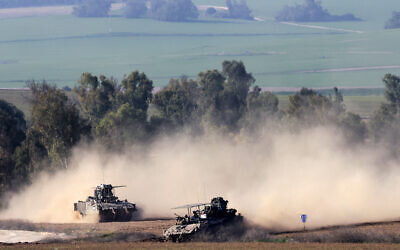 This picture taken from southern Israel shows Israeli armored vehicles along the border with the Gaza Strip on December 31, 2023 (Menahem KAHANA / AFP)