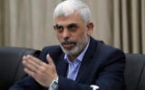 Yahya Sinwar, head of Hamas in Gaza, greets his supporters during a meeting with leaders of Palestinian factions at his office in Gaza City, April 13, 2022. (AP Photo/Adel Hana)