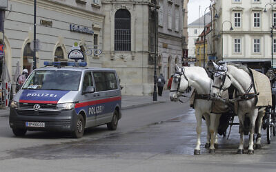File: A police van drives past Fiaker horses at St. Stephen's Cathedral in Vienna, Austria, March 15, 2023. (AP Photo/Heinz-Peter Bader) File: A police van drives past Fiaker horses at St. Stephen's Cathedral in Vienna, Austria, March 15, 2023. (AP Photo/Heinz-Peter Bader)