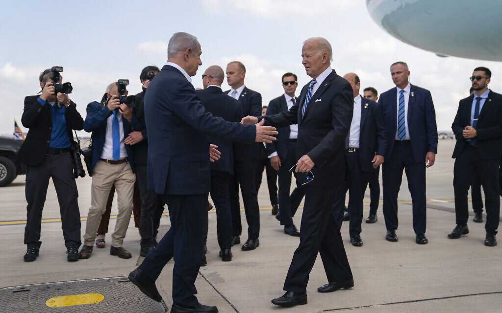 US President Joe Biden (right) is greeted by Prime Minister Benjamin Netanyahu after arriving at Ben Gurion International Airport, October 18, 2023. (AP/Evan Vucci) US President Joe Biden (right) is greeted by Prime Minister Benjamin Netanyahu after arriving at Ben Gurion International Airport, October 18, 2023. (AP/Evan Vucci)