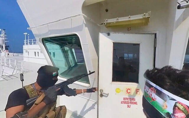 This photo released by the Houthi Media Center shows Houthi forces boarding the cargo ship Galaxy Leader on November 19, 2023. Yemen's Houthis have seized the ship in the Red Sea off the coast of Yemen after threatening to seize all vessels owned by Israeli companies. (Houthi Media Center via AP)