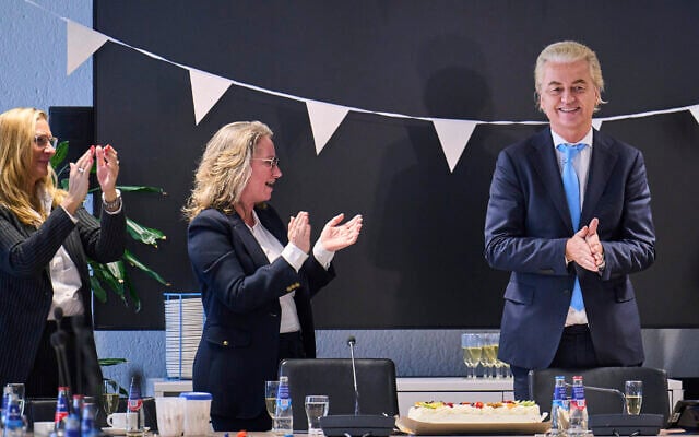 Far-right Party for Freedom leader Geert Wilders, right, celebrates with Fleur Agema, section left, and other party members after winning the most votes in a general election, in The Hague, Netherlands, November 23, 2023. (AP Photo/Phil Nijhuis)