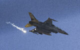 An Israeli fighter jet releases flares as it flies over the Gaza Strip, as seen from southern Israel, Dec. 9, 2023. (AP Photo/Leo Correa)