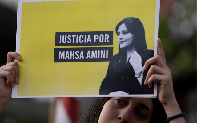 FILE - A woman holds a sign that reads in Spanish "Justice for Mahsa Amini" as she protests against the death of Amini, an Iranian woman who died while in police custody in Iran, in front of the Iranian embassy in Buenos Aires, Argentina, September 27, 2022. (AP Photo/Natacha Pisarenko, File) FILE - A woman holds a sign that reads in Spanish "Justice for Mahsa Amini" as she protests against the death of Amini, an Iranian woman who died while in police custody in Iran, in front of the Iranian embassy in Buenos Aires, Argentina, September 27, 2022. (AP Photo/Natacha Pisarenko, File)