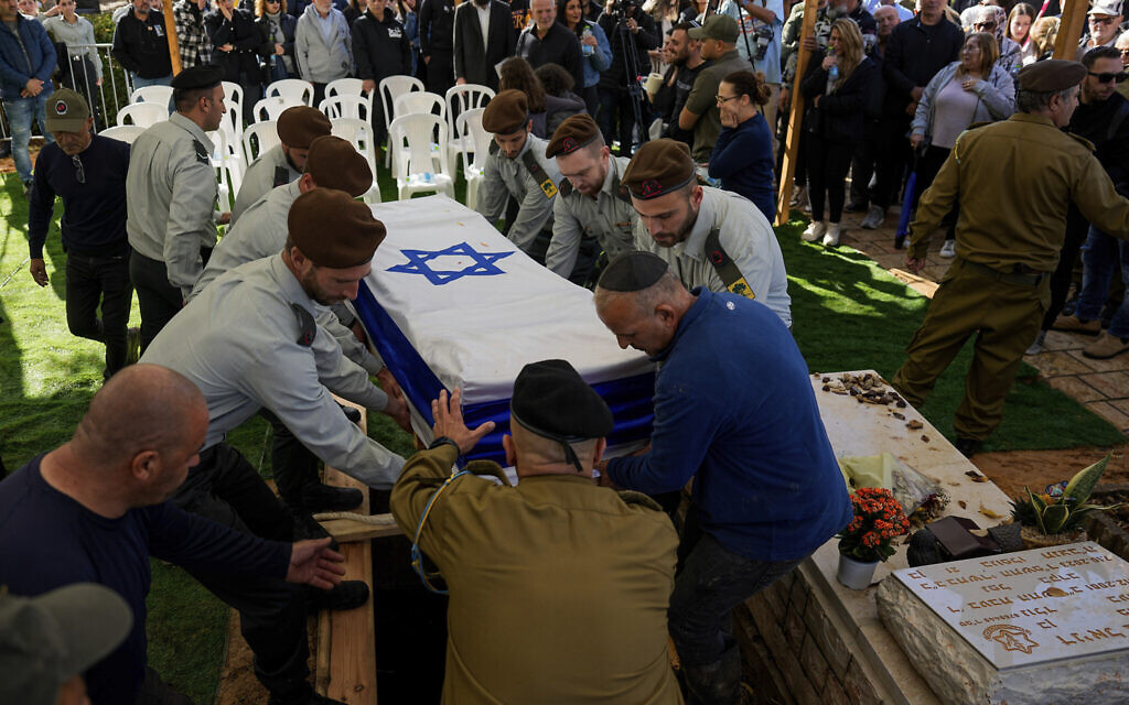 Israeli soldiers carry the flag-draped casket of Major Roei Meldasi during his funeral in Afula, December 13, 2023. (AP/Ariel Schalit)