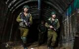 Israeli soldiers are seen in a tunnel that the military says Hamas terrorists used to attack the Erez crossing in the northern Gaza Strip, December 15, 2023 (AP Photo/Ariel Schalit)