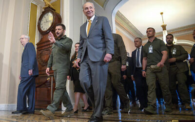 FILE - Ukrainian President Volodymyr Zelensky, second from left, walks with Senate Minority Leader Mitch McConnell of Kentucky, left, and Senate Majority Leader Chuck Schumer of New York, right, at Capitol Hill on September 21, 2023, in Washington. (AP Photo/Mark Schiefelbein)