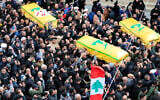 Mourners carry the coffins of a Hezbollah fighter and two other people who killed by an Israeli airstrike that hit their house in Bint Jbeil, South Lebanon, December 27, 2023. (Mohammed Zaatari/AP)