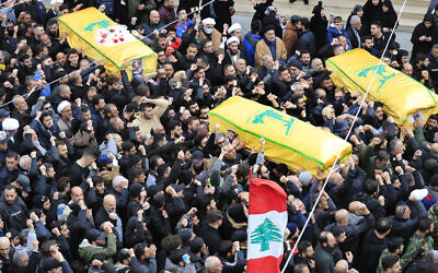 Mourners carry the coffins of a Hezbollah fighter and two other people who killed by an Israeli airstrike that hit their house in Bint Jbeil, South Lebanon, December 27, 2023. (Mohammed Zaatari/AP)