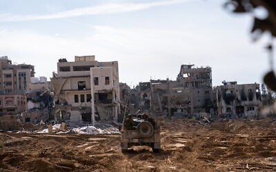Israeli troops in a Humvee drive in northern Gaza's Salatin, close to Jabaliya, December 7, 2023. (Emanuel Fabian/Times of Israel)