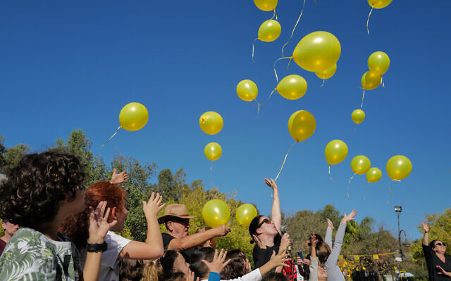 People gather with yellow balloons calling for the release of Israelis abducted by Hamas terrorists in Gaza, at Aniam's Artist's Village, Golan Heights on December 1, 2023 (Michael Giladi/Flash90) People gather with yellow balloons calling for the release of Israelis abducted by Hamas terrorists in Gaza, at Aniam's Artist's Village, Golan Heights on December 1, 2023 (Michael Giladi/Flash90)