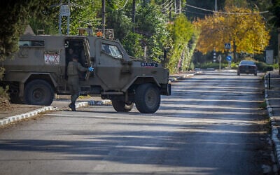 Israeli soldiers near the scene where a missile launched from Lebanon hit a group of Israeli soldier and civilians in Moshav Beit Hillel, near the Israeli border with Lebanon, December 3, 2023. (Ayal Margolin/Flash90)