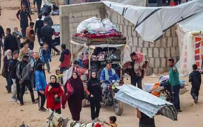 Palestinians are seen at a temporary camp set up for those who were evacuated from their homes near the Egyptian border in Rafah, in the southern Gaza Strip on December 5, 2023. (Atia Mohammed/Flash90)