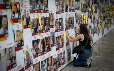 Israelis put up posters of the civilians held hostage by Hamas terrorists in Gaza, at 'Hostage Square' in Tel Aviv, December 6, 2023. (Miriam Alster/FLASH90)