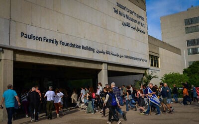People take cover from missiles inside the Tel Aviv Museum of Art during a protest calling for the release of hostages at Hostage Square in Tel Aviv, December 8, 2023. (Tomer Neuberg/ Flash90)
