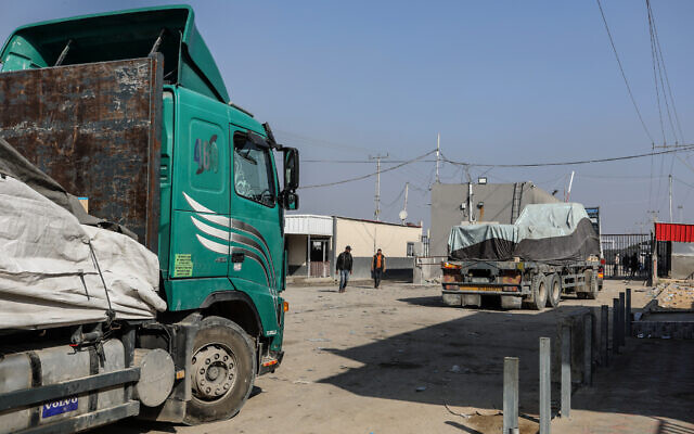 Trucks carrying humanitarian aid arrive at the Palestinian side of the Kerem Shalom border crossing, in the southern Gaza Strip, on December 18, 2023. (Abed Rahim Khatib/Flash90)