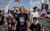 Released Israeli hostage Aviva Siegel marches with teenagers from Kibbutz Kfar Aza during a five-day march from Tel Aviv to the Jerusalem Knesset on December 28, 2023. (Chaim Goldberg/Flash90