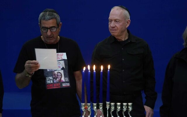 Defense Minister Yoav Gallant lights Hanukkah candles in Tel Aviv with family members of hostages, December 10, 2023. (Ariel Hermoni/Defense Ministry) Defense Minister Yoav Gallant lights Hanukkah candles in Tel Aviv with family members of hostages, December 10, 2023. (Ariel Hermoni/Defense Ministry)