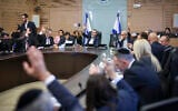 FILE - MKs in the Knesset Finance Committee vote on the supplementary budget to cover the costs of the war with Hamas in Gaza, December 12, 2023. (Noam Moskowitz/Knesset Spokesperson's Department)