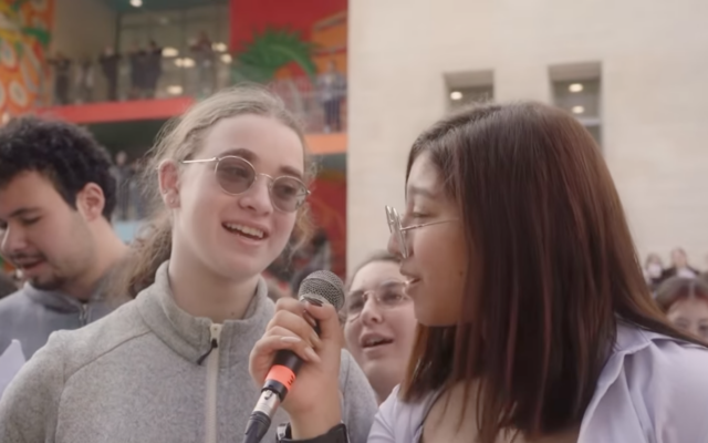Released Hamas captive Mia Leimberg with a school friend at the Jerusalem High School for the Arts after she was released on November 28, 2023 from nearly two months in Hamas captivity (Courtesy screenshot)
