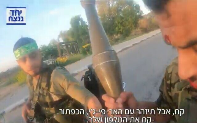 Hamas terrorists at the gate of Kibbutz Sufa in southern Israel on October 7, 2023, in footage filmed by Hamas, screened on Channel 12 on December 31, 2023. (Screenshot used in accordance with Clause 27a of the Copyright Law) Hamas terrorists at the gate of Kibbutz Sufa in southern Israel on October 7, 2023, in footage filmed by Hamas, screened on Channel 12 on December 31, 2023. (Screenshot used in accordance with Clause 27a of the Copyright Law)