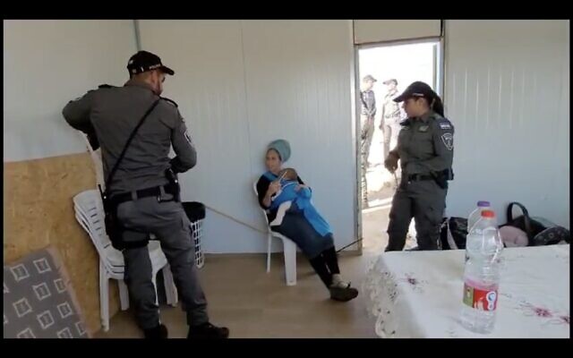 Screenshot of video footage posted by settler activists of one of the residents of the illegal outpost of Mitzpe Kedem in the South Hebron Hills region of the West Bank being evacuated by police ahead of the demolition of the outpost on December 4, 2023 (Screenshot: used in accordance with Clause 27a of the Copyright Law) Screenshot of video footage posted by settler activists of one of the residents of the illegal outpost of Mitzpe Kedem in the South Hebron Hills region of the West Bank being evacuated by police ahead of the demolition of the outpost on December 4, 2023 (Screenshot: used in accordance with Clause 27a of the Copyright Law)