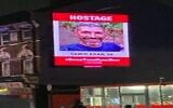 A projected image of a hostage held by Hamas in the Gaza Strip in London, before it was taken down by an advertising company due to threats, from a Channel 12 news report, December 12, 2023. (Channel 12 screenshot: used in accordance with Clause 27a of the Copyright Law)
