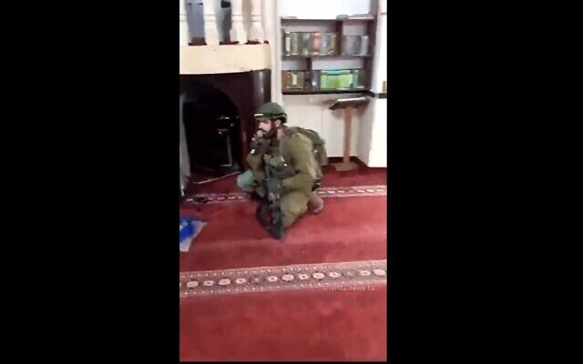 An IDF soldier sings into the loudspeaker of a mosque in the West Bank city of Jenin, December 14, 2023. (X video screenshot: used in accordance with Clause 27a of the Copyright Law) An IDF soldier sings into the loudspeaker of a mosque in the West Bank city of Jenin, December 14, 2023. (X video screenshot: used in accordance with Clause 27a of the Copyright Law)