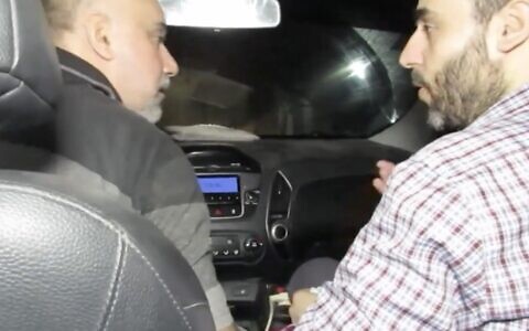 A screenshot of an undated video released by the Israel Defense Forces on December 17, 2023, shows Hamas commander Muhammad Sinwar, right, riding in a car traveling through a tunnel under the Gaza Strip. (Screenshot: Israel Defense Forces)