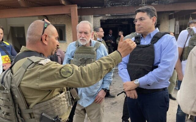 Mike Huckabee (center) stands with former Israeli envoy to the UN Danny Danon in Kfar Aza, December 20, 2023 (Sam Sokol) Mike Huckabee (center) stands with former Israeli envoy to the UN Danny Danon in Kfar Aza, December 20, 2023 (Sam Sokol)